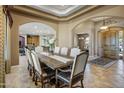 Sophisticated dining room showcasing a large table, beautiful chairs, and a view into multiple rooms, creating an open feel at 21384 E Excelsior Ave, Queen Creek, AZ 85142