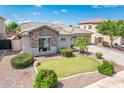 Landscaped front yard showcasing manicured lawn and stone detail on exterior at 2171 E Iris Dr, Chandler, AZ 85286