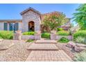 Welcoming entrance with stone archway, manicured greenery, and brick stairs at 2383 E Zion Way, Chandler, AZ 85249