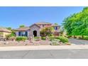 Charming two-story home featuring a stone-accented facade, landscaped yard, and inviting entrance at 2383 E Zion Way, Chandler, AZ 85249