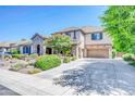 Inviting two-story home with lush landscaping, stone accents, and a spacious driveway at 2383 E Zion Way, Chandler, AZ 85249