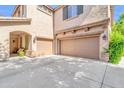 Spacious three-car garage and beautiful stucco exterior with accent lighting at 2383 E Zion Way, Chandler, AZ 85249
