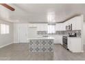 Bright kitchen featuring white cabinets, stylish backsplash, stainless steel appliances, and a center island at 240 N Monte Vista St, Chandler, AZ 85225
