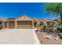 Charming home with desert landscaping, a two-car garage, tile roofing, and solar panels at 27244 W Potter Dr, Buckeye, AZ 85396