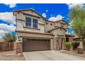Attractive home featuring a two-car garage, stone accents, and tasteful landscaping at 2748 E Dennisport Ave, Gilbert, AZ 85295