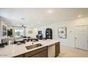 Modern kitchen island boasts sleek countertops, stainless steel appliances, and ample storage, ideal for cooking and gathering at 32693 N Jasper St, San Tan Valley, AZ 85143