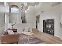 Grand living room with high ceilings, a fireplace, and large windows that flood the space with light at 3624 N Paseo Del Sol --, Mesa, AZ 85207