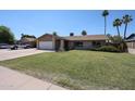 Inviting single-story home with a lush front yard and a welcoming exterior appeal at 3633 W Redfield Rd, Phoenix, AZ 85053