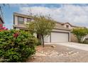 Charming front exterior view of a two-story home with a two-car garage and desert landscaping at 41678 N Salix Dr, San Tan Valley, AZ 85140