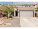Charming front exterior view of a two-story home with a two-car garage and desert landscaping at 41678 N Salix Dr, San Tan Valley, AZ 85140