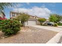 Charming two-story home with a desert-landscaped front yard, long driveway, and neutral color palette at 41678 N Salix Dr, San Tan Valley, AZ 85140