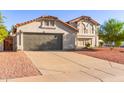 Well-maintained home boasts desert landscaping, tile roof, and a spacious driveway leading to a gray garage door at 47 W Calle Monte Vis, Tempe, AZ 85284