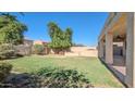 Lush backyard with green grass and built in BBQ at 4730 N 111Th Ln, Phoenix, AZ 85037