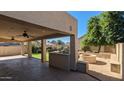 Large covered patio with a BBQ and a fire pit in the backyard at 4730 N 111Th Ln, Phoenix, AZ 85037