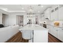 Bright, open kitchen featuring modern lighting, a large center island, and stainless steel appliances at 521 E Aurora Dr, San Tan Valley, AZ 85140