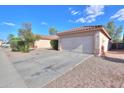 A nice driveway leads to a charming single-story home featuring a well-maintained yard and a two-car garage at 537 W Kingman Dr, Casa Grande, AZ 85122