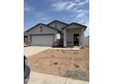 New construction single-story home with a white garage door and desert landscaping at 5702 E Iris Dr, Florence, AZ 85132