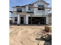 New home construction featuring a two-story design with visible framework and covered with protective moisture wrap material at 6008 E Artemis Dr, Florence, AZ 85132