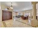 Open-concept foyer showcasing tile flooring, a dining area, and a living room with large windows at 7418 E Black Rock Rd, Scottsdale, AZ 85255