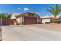 Wide driveway leading to a two-car garage, showcasing ample parking space at 7526 W Windrose Dr, Peoria, AZ 85381