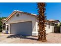 Single-story home with a two-car garage, neutral paint, and desert landscaping at 840 E Baylor Ln, Chandler, AZ 85225