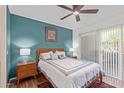 Cozy bedroom with modern decor, bedside tables, and a sliding glass door at 9450 E Becker Ln # 1046, Scottsdale, AZ 85260