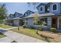 Attractive townhouse with blue siding,dormer windows, and lush green lawn at 10101 N 91St Ave # 111, Peoria, AZ 85345