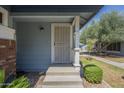 Charming front porch with a secure screen door and manicured landscaping at 10101 N 91St Ave # 111, Peoria, AZ 85345