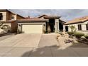 Inviting single-Gathering home showcasing desert landscaping and a convenient two-car garage at 14345 N 101St St, Scottsdale, AZ 85260