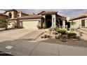 Beautiful single-Gathering home boasting meticulous desert landscaping and a spacious driveway at 14345 N 101St St, Scottsdale, AZ 85260