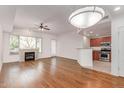 Open living room boasts a fireplace, hardwood floors, and modern lighting at 16 W Encanto Blvd # 26, Phoenix, AZ 85003