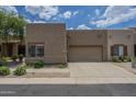 Single-story home featuring a private garage and driveway with desert landscaping at 1650 S Crismon Rd # 63, Mesa, AZ 85209