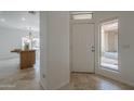 Bright foyer featuring travertine tile, clerestory window and an open view to the kitchen at 1650 S Crismon Rd # 63, Mesa, AZ 85209