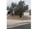 Two-story home featuring an attached two-car garage, desert landscaping and mature trees at 1655 W Stanford Ave, Gilbert, AZ 85233