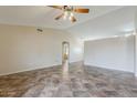 Spacious living room enhanced by a ceiling fan and neutral paint palette at 1660 E Zinnia St, Casa Grande, AZ 85122