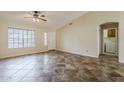 Inviting living room with ceiling fan, large window, and convenient access to the laundry room at 1660 E Zinnia St, Casa Grande, AZ 85122