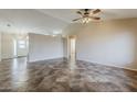 Open-concept living room features beautiful tile floors, a ceiling fan, and neutral paint at 1660 E Zinnia St, Casa Grande, AZ 85122