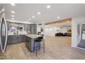 Open-concept kitchen with granite countertops, gray cabinets, and seamless flow into the living room at 19615 N 18Th Dr, Phoenix, AZ 85027