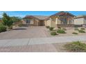 Charming home with a brick paved driveway, stone accents, and manicured landscaping at 2518 E Novak Way, Phoenix, AZ 85042
