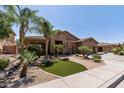 Charming home featuring a three-car garage, desert landscaping, and a stone-accented entry at 27421 N 22Nd Ln, Phoenix, AZ 85085