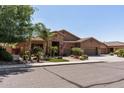 Charming home featuring a three-car garage, desert landscaping, and a stone-accented entry at 27421 N 22Nd Ln, Phoenix, AZ 85085