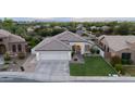 Stunning aerial view of a well-kept single-story home with a pristine lawn, three-car garage, and beautiful landscaping in a quiet neighborhood at 2982 S Holguin Way, Chandler, AZ 85286