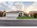 Attractive single-story home features a manicured lawn, a convenient three-car garage, and appealing architectural design under a sunny sky at 2982 S Holguin Way, Chandler, AZ 85286