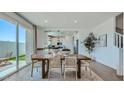 Bright dining area featuring modern furnishings and seamless access to outdoor patio at 3344 S Lotus Ave, Mesa, AZ 85212