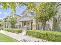 Beautiful home featuring lush green trees and landscaping that frame this charming two-story home at 3893 E Gideon Way, Gilbert, AZ 85296