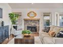 Cozy living room with a brick fireplace, plush seating, and stylish decor at 4220 E San Angelo Ave, Gilbert, AZ 85234
