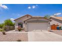 Charming single-story home featuring a two-car garage and low-maintenance desert landscaping in front yard at 4518 W Carson Rd, Laveen, AZ 85339