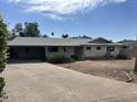 Single-story home with a carport and desert landscaping; a promising fixer-upper with great potential at 4808 N 69Th St, Scottsdale, AZ 85251