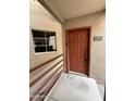 This is a front door view of unit 241 with a window next to the door at 4850 E Desert Cove Ave # 241, Scottsdale, AZ 85254