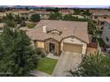 Aerial view of a single-Gathering home showcasing its landscaping, roof, and surrounding neighborhood at 6299 S Roanoke St, Gilbert, AZ 85298